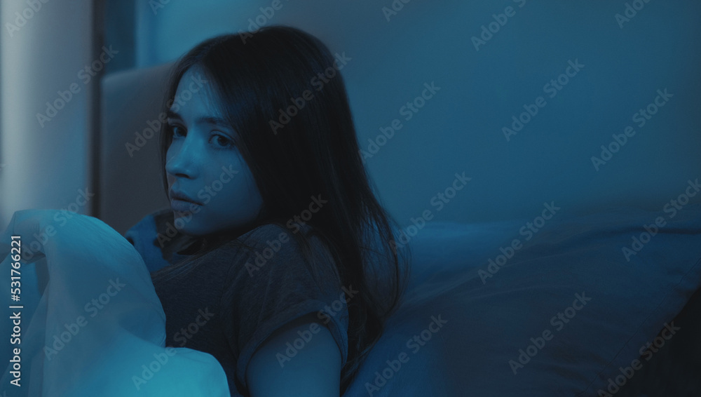 Bed nightmare. Sleep disorder. Bad dream. Disturbed scared woman waking