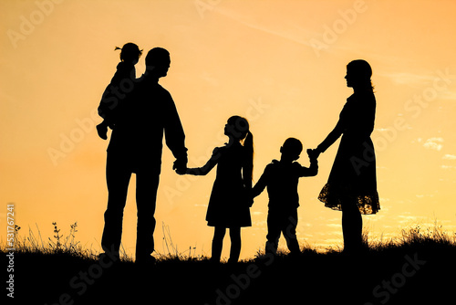 happy family by the sea on nature silhouette background