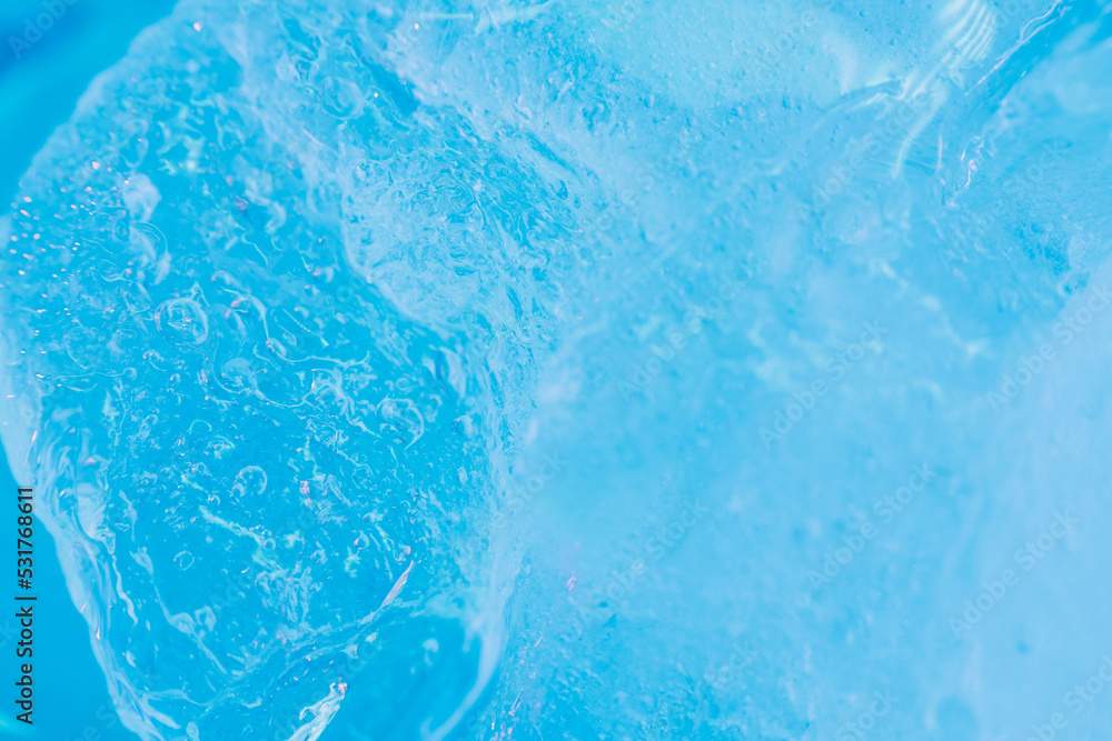 Global warming. Melting blue ice macro shot. Natural crystal clear flowing water. Creative background Global warming. Melting blue ice macro shot. Natural crystal clear flowing water. Creative background