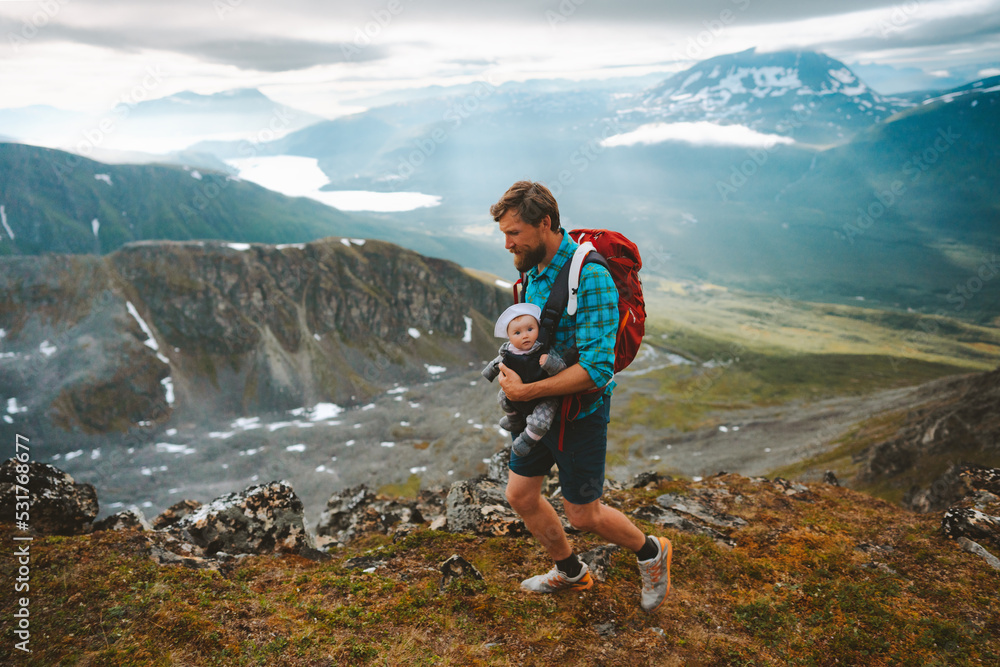 Obraz premium Active family vacations father trail running with baby outdoor travel adventure vacation healthy lifestyle dad with kid in mountains of Norway