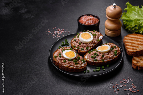 Delicious healthy sandwich with tuna, croutons, boiled egg, herbs and butter