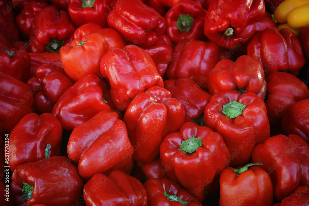 Red pepper on the counter in the supermarket. A large amount of red pepper in a pile Red pepper on the counter in the supermarket. A large amount of red pepper in a pile