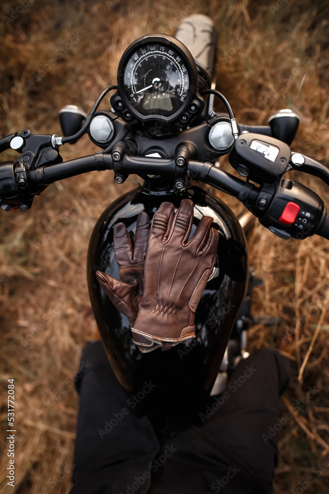 Leather gloves lying on the gas tank of a motorcycle Leather gloves lying on the gas tank of a motorcycle