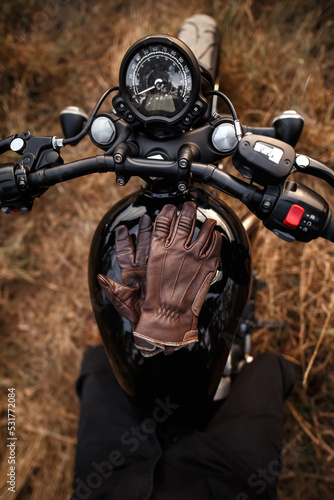 Leather gloves lying on the gas tank of a motorcycle