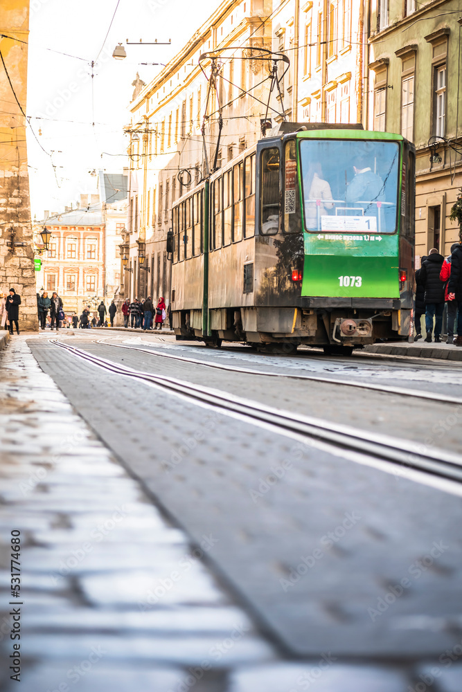 people walk in the center of the old city of Lviv. Lviv tram
