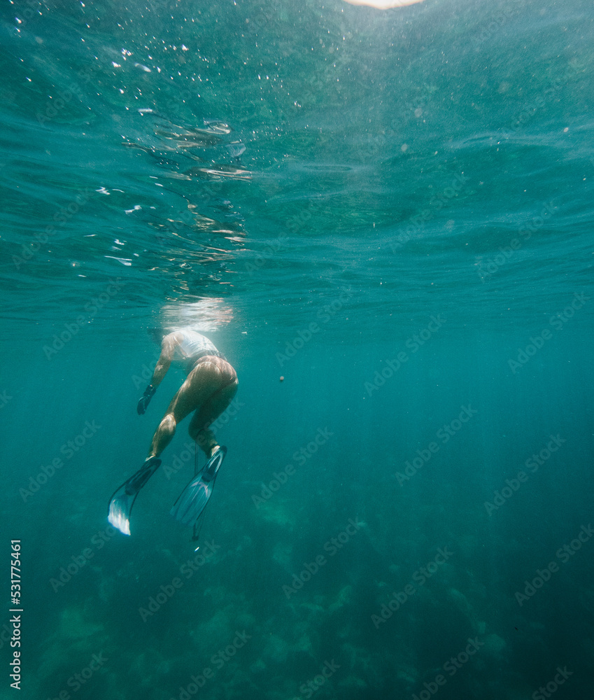 Girl Spearfishing in Turquoise water