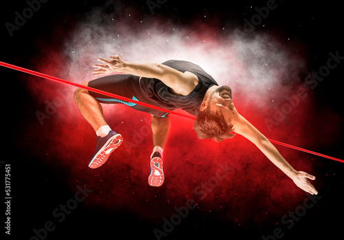 Man in action of high jump photo