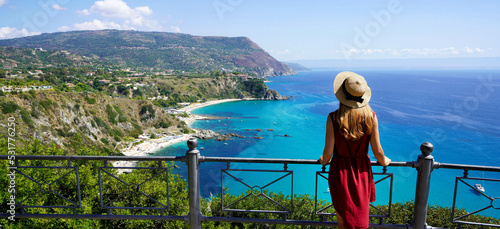 Traveling in Italy. Panoramic view of elegant woman with hat in Capo Vaticano in the Coast of the Gods, Calabria, Italy.