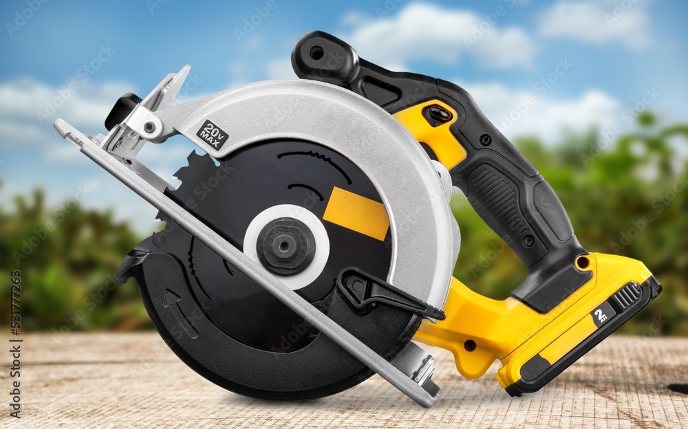 Naklejka premium Circular saw electric tool on the natural background
