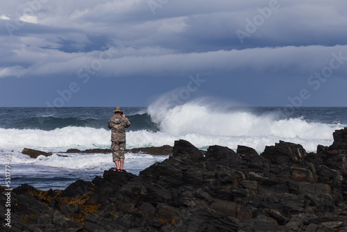 man looking at the stormy sea