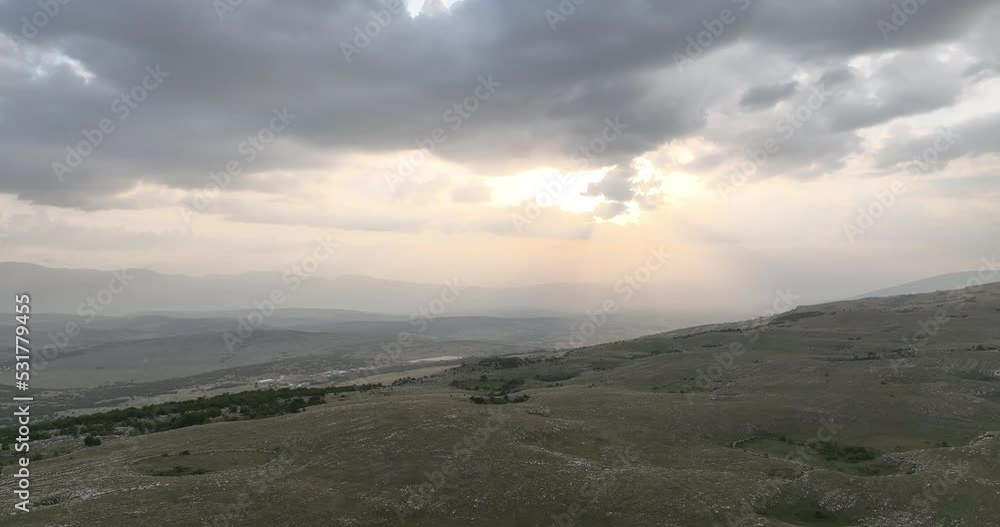 Aerial shot of meadows covered with soft mist on a cloudy day in the countryside. Aerial scenic candid authentic rural view Aerial shot of meadows covered with soft mist on a cloudy day in the countryside. Aerial scenic candid authentic rural view