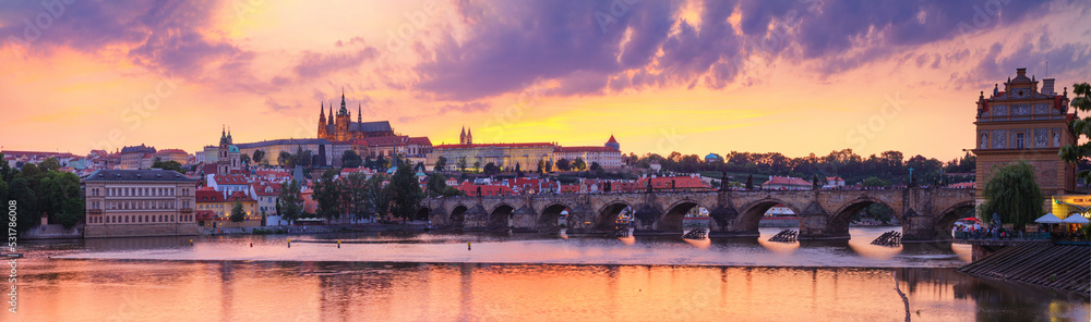 City summer landscape at sunset, panorama, banner - view of the Charles Bridge and castle complex Prague Castle in the historical center of Prague, Czech Republic