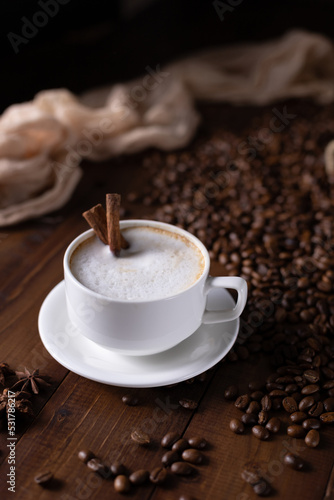 Cup of coffee and milk beans at wood table. Homemade coffee at table