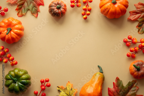 Autumn flat lay background. Pumpkins and fall leaves. Autumn decorations with copy space.