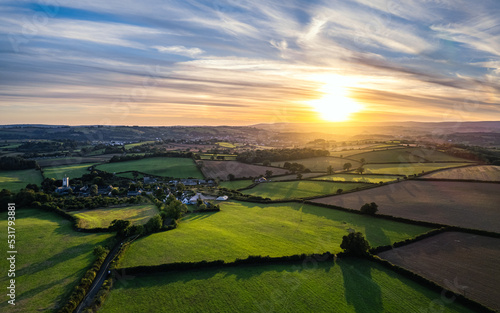 Sunset over Farmlands and Fields from a drone, Berry Pomeroy, Devon, England, Europe photo