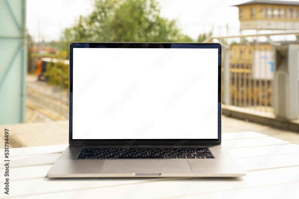 Laptop with white screen in business office or shopping mall. Empty copy space, blank screen mockup. Soft focus laptop with interor background. Travel, study and office work concept Laptop with white screen in business office or shopping mall. Empty copy space, blank screen mockup. Soft focus laptop with interor background. Travel, study and office work concept