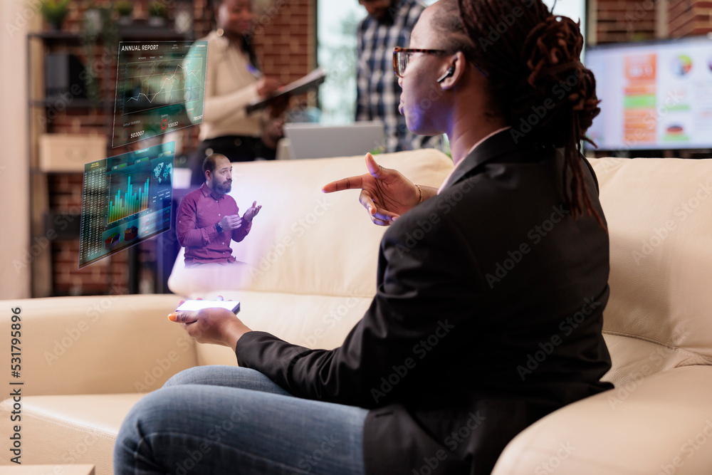 Businesswoman using augmented reality hologram in company office ...
