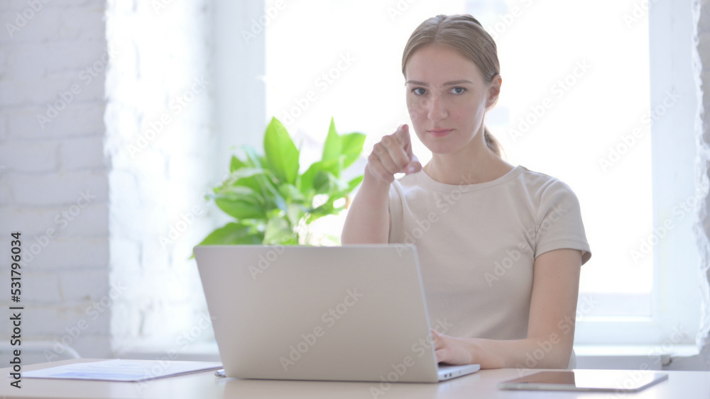 Woman Pointing at Camera while using Laptop Woman Pointing at Camera while using Laptop