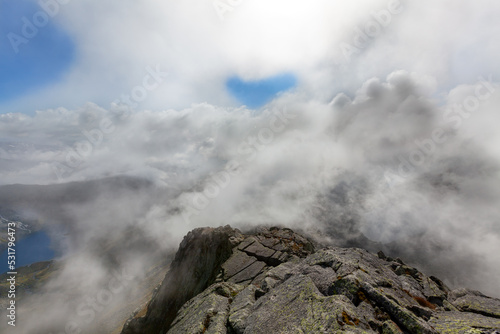 Dramatic mountains Norway. Cloudy mountain top in Rosendal.  Norwegian nature. © KRNO