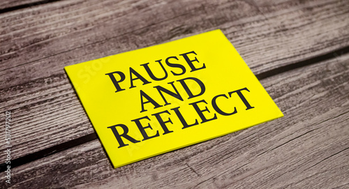 pause and reflect the phrase on yellow paper and pen