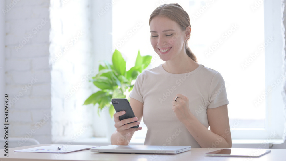 Excited Woman Celebrating Success while Using Smartphone Excited Woman Celebrating Success while Using Smartphone