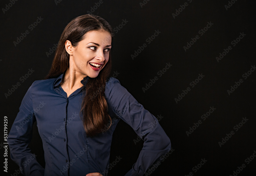Beautiful thinking excited smiling business woman with folded arms on presentation on black background with empty copy space for text. Closeup