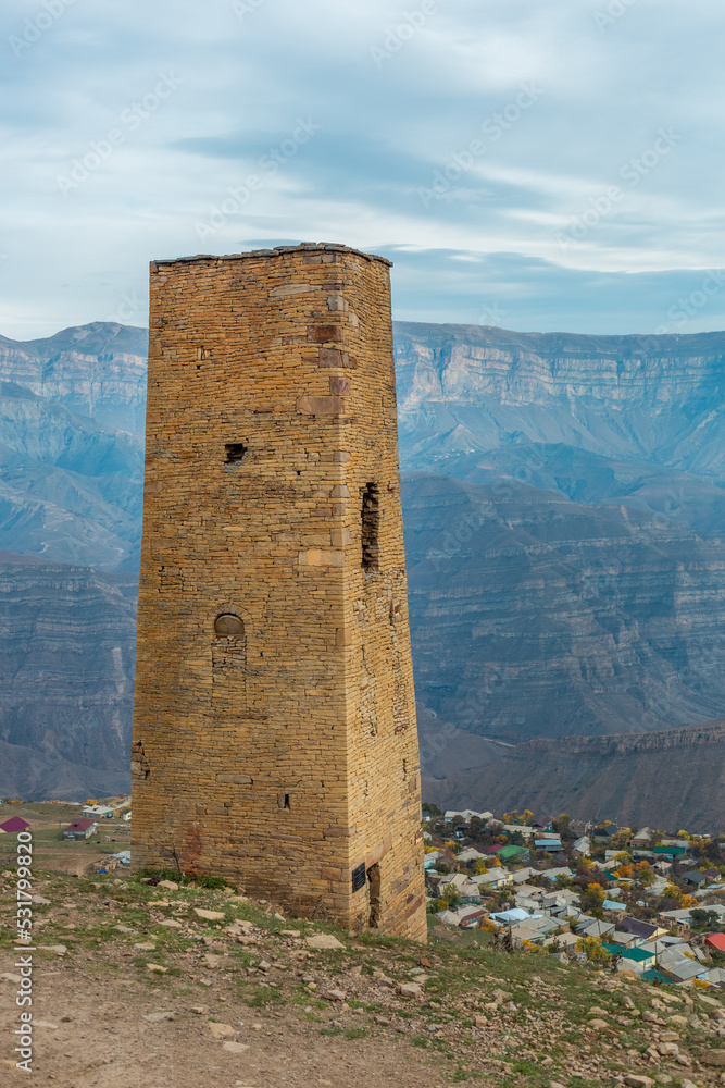 Tower of the abandoned village of Goor, Dagestan, Russia. Stone tower with panoramic view of the Goor village among the mountains Tower of the abandoned village of Goor, Dagestan, Russia. Stone tower with panoramic view of the Goor village among the mountains