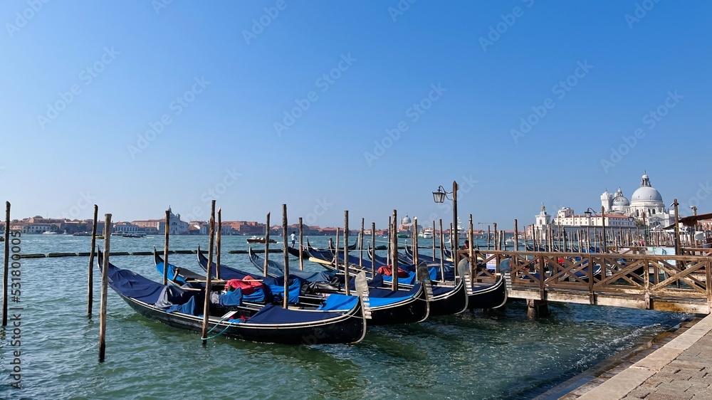 Gondolas moored by Piazza San Marco with San Giorgio di Maggiore church in Venice, Italy