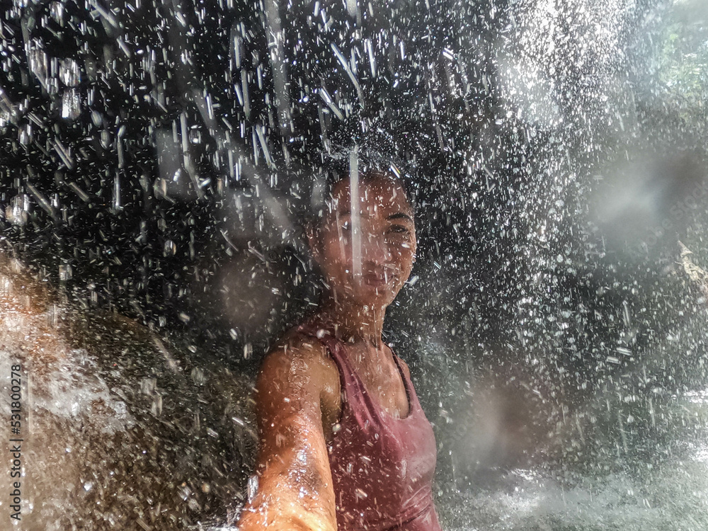 Fototapeta premium Tourist enjoying the hot spring waterfall of Finca Paraiso, Rio Dulce, Guatemala