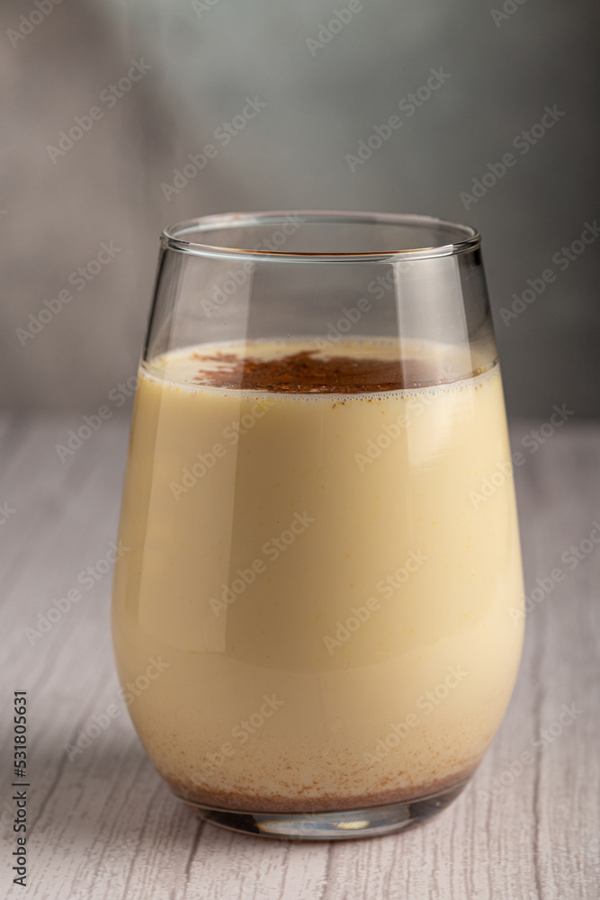 Eggnog cup with cinnamon powder. Eggnog cup with cinnamon powder.