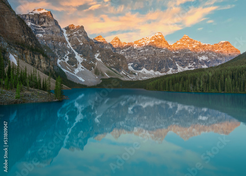 turquoise Moraine Lake in Alberta  Canada  with rocky mountains and sunrise. 