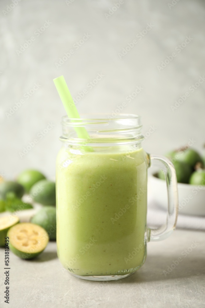 Fresh feijoa smoothie in mason jar on light table, closeup Fresh feijoa smoothie in mason jar on light table, closeup