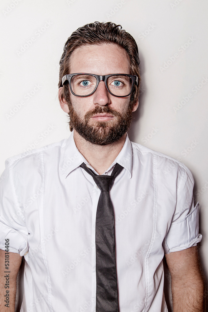 Caucasian blond-haired man with glasses, wearing a white shirt looking at the camera. Caucasian blond-haired man with glasses, wearing a white shirt looking at the camera.
