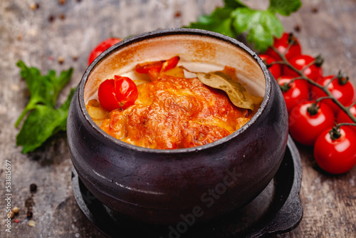 Billede på lærred Crock pot pork roast with vegetables and cheese on wooden rustic table