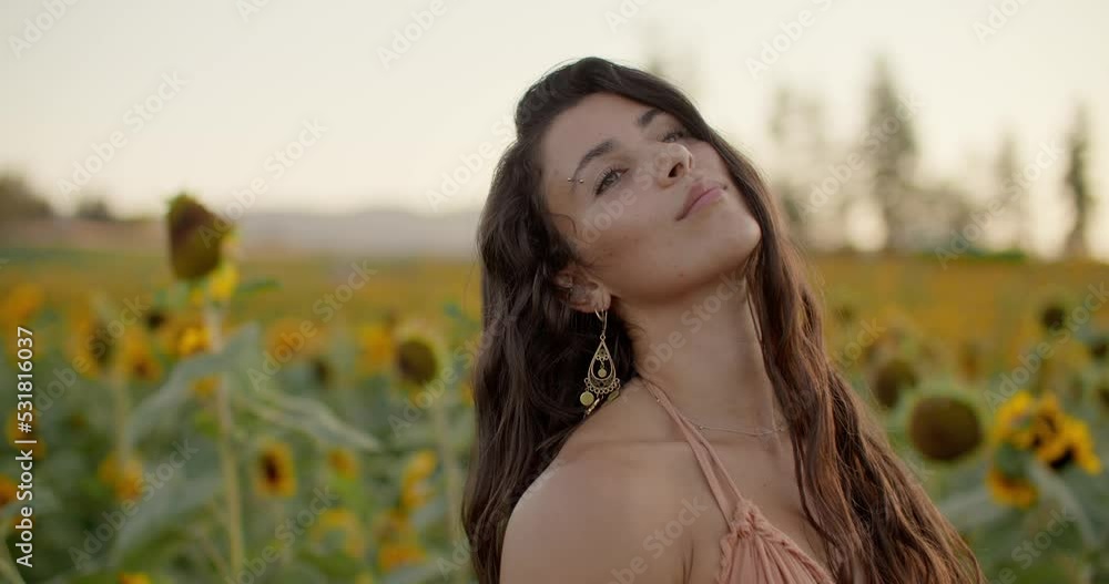 Portrait of beautiful, dreamy female model, sunflower field Portrait of beautiful, dreamy female model, sunflower field