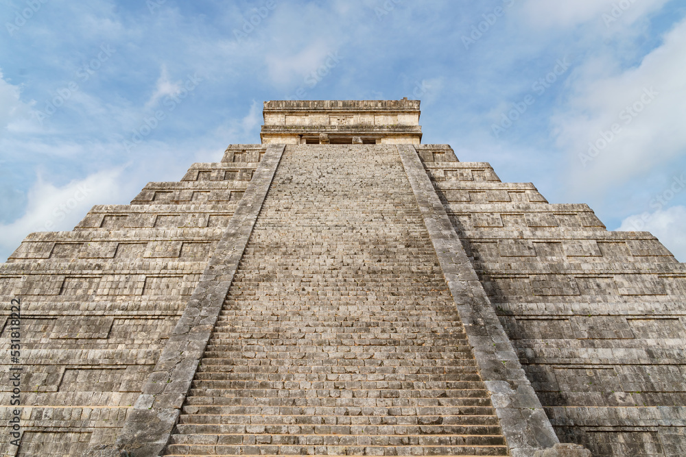 View up the main steps of El Castillo (Temple of Kukulkan) in Chichen Itza with blue sky View up the main steps of El Castillo (Temple of Kukulkan) in Chichen Itza with blue sky