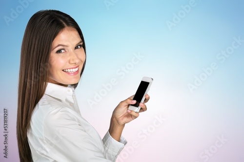 Young happy woman using phone and posing