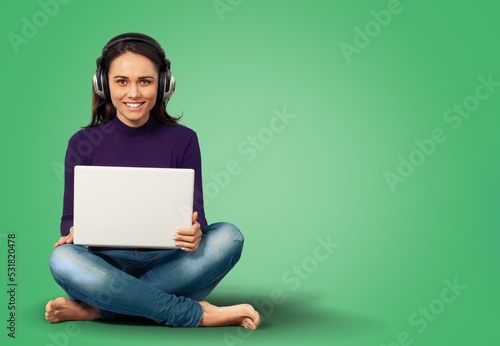 Young girl student sitting on floor with laptop computer © BillionPhotos.com