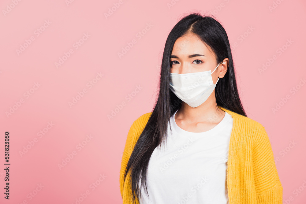 Closeup face Asian beautiful young woman wearing medical mask protection against germs for prevent infection coronavirus, COVID-19, studio shot isolated on pink background, medical health care concept Closeup face Asian beautiful young woman wearing medical mask protection against germs for prevent infection coronavirus, COVID-19, studio shot isolated on pink background, medical health care concept