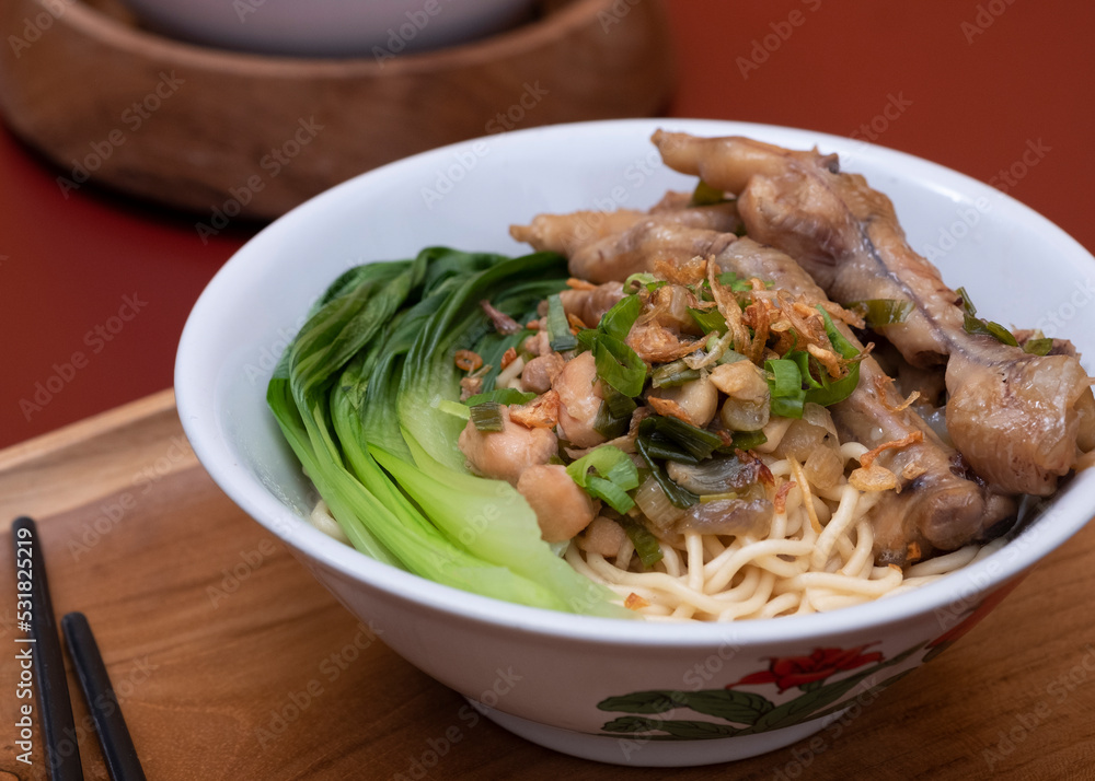 Mie ayam ceker (Chicken noodle with tasty chicken feet), Indonesian street food consist of noodle, vegetables, chicken meat and chicken feet. Popular food in the country