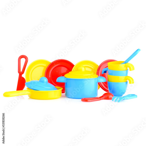A set of children's toy dishes isolated on a white background. Plastic set: mugs, plates, saucepan, frying pan. Children's kitchen. Educational role-playing games for children