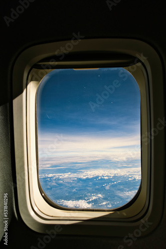View of blue cloudy sky from airplane window