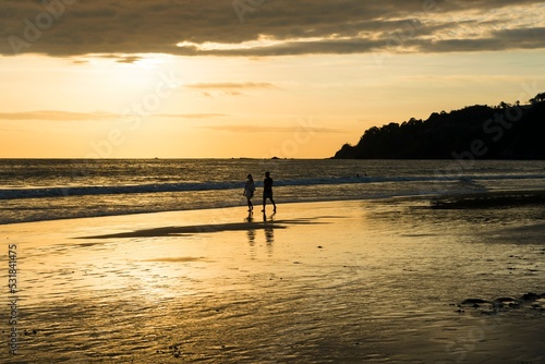 Couple, Man and Woman, Walk on the beach, Sunset, Playa Espadilla, National Park Manuel Antonio, Costa Rica, Central America photo