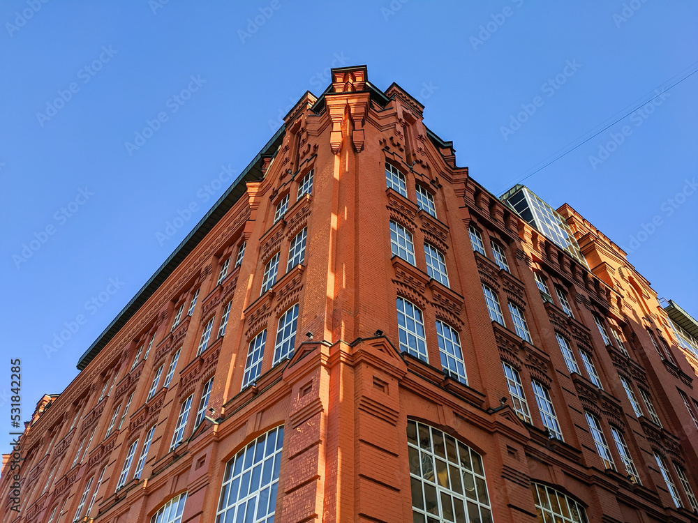 Moscow, Russia - March 01, 2022: Bottom view of the corner of a red brick building with ancient architecture in Moscow