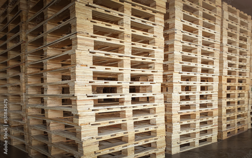 Wooden Pallets Stacked in Storage Warehouse. Wooden Pallets Stacked in Storage Warehouse.