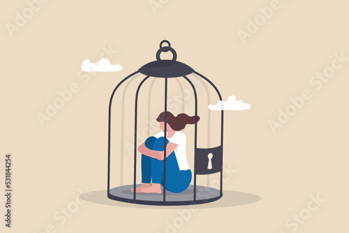 Stuck or trapped, fixed mindset or metal illness problem, anxiety or depression, solitude and loneliness, fear to get outside concept, depressed woman lock herself sit inside birdcage.