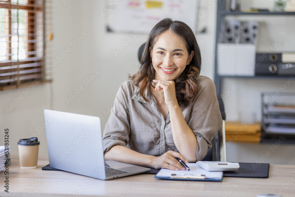 Young Asian businesswoman attending a virtual working financial report analysis Business Documents in workplace an home office, asian woman working contract. Young Asian businesswoman attending a virtual working financial report analysis Business Documents in workplace an home office, asian woman working contract.