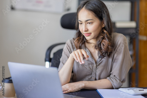 Young Asian businesswoman attending a virtual working financial report analysis Business Documents in workplace an home office  asian woman working contract.