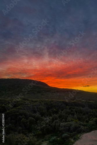 High cloud sunrise over the beach and mountain