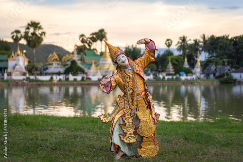 The classical Burmese traditional Dancing Mask perform show the cultural costume posing and wearing beautiful a golden dress.